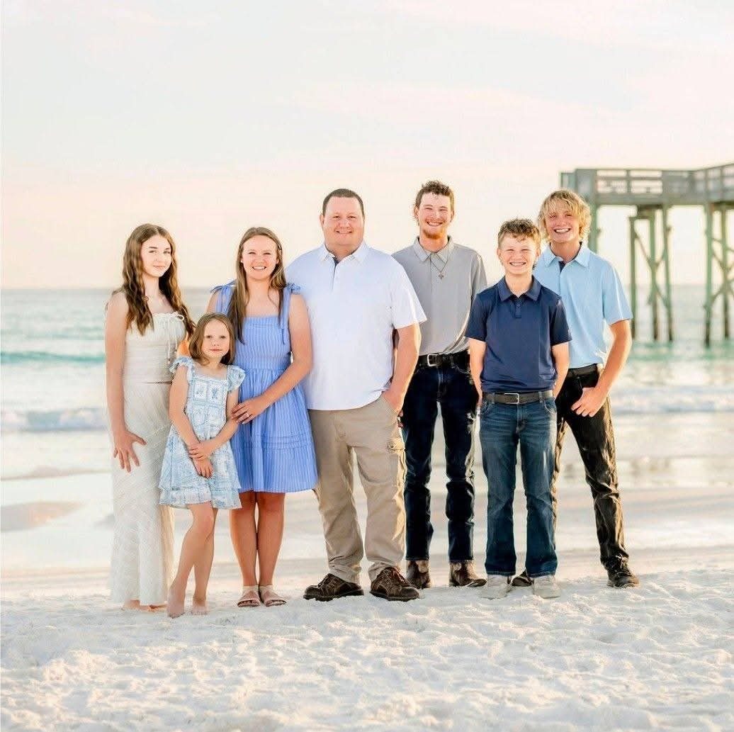 Mr. Fence owner Joshua Glover with his wife and kids on Panama City Beach