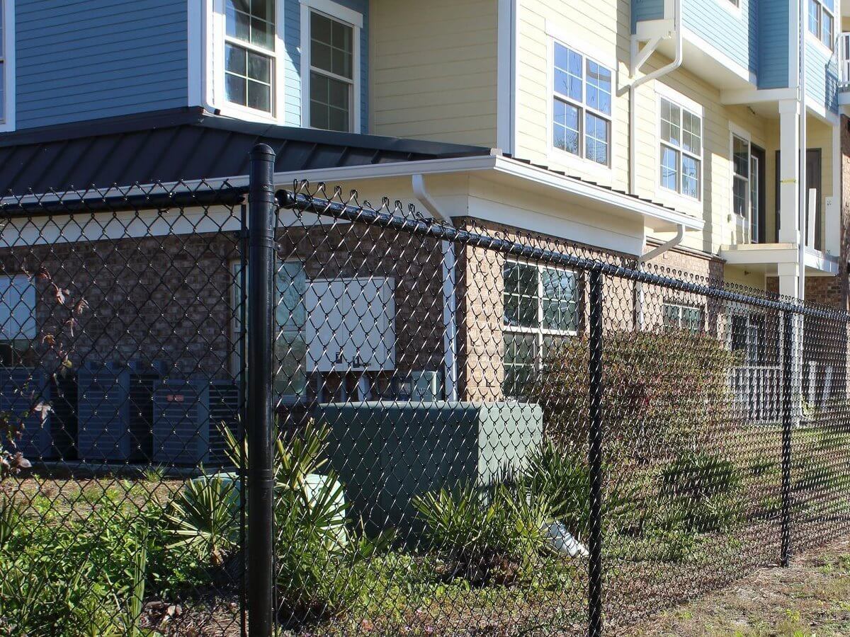 Black chain link fence around a backyard