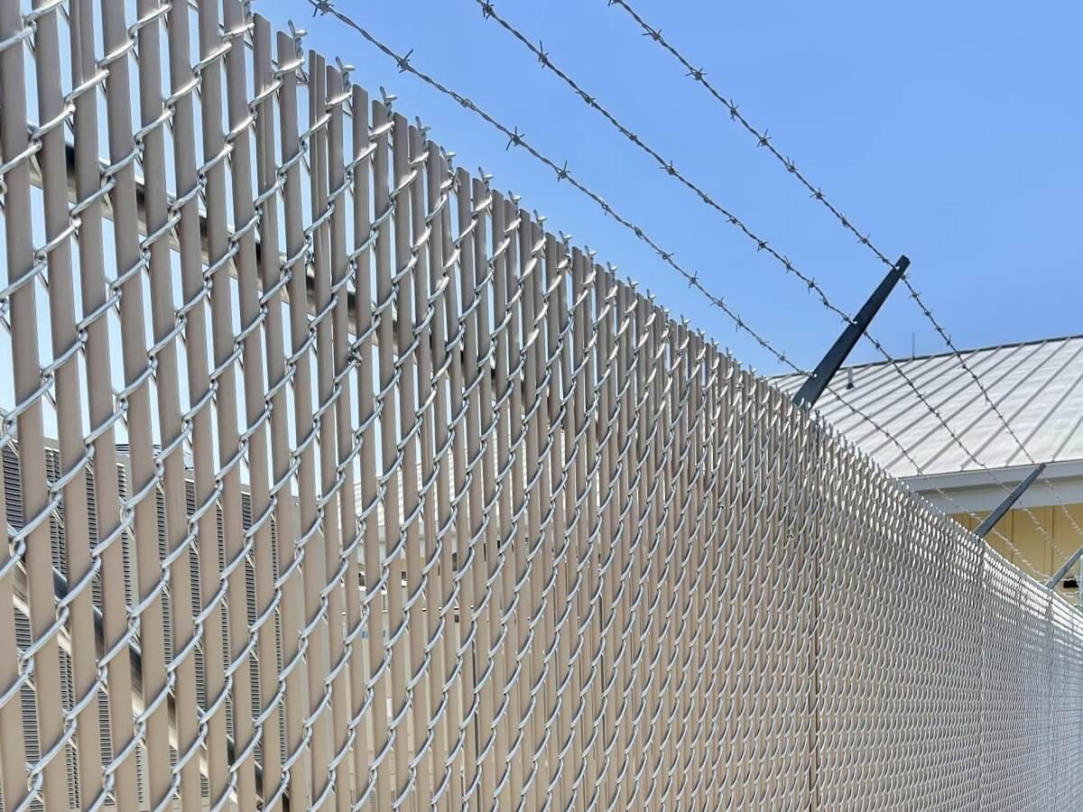 Commercial chain link fence with barbed wire
