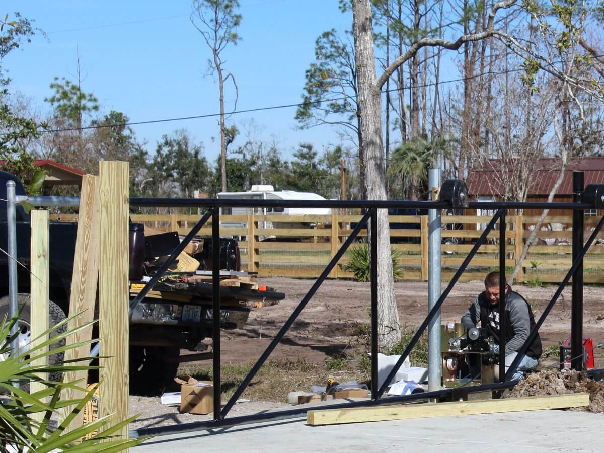 Black chain link driveway gate with automatic operator