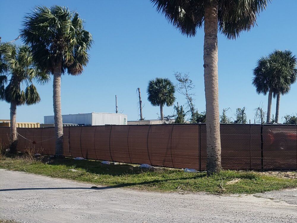 Long run of temporary fence with privacy screen