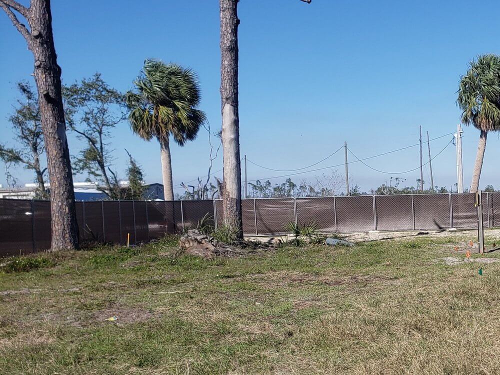 Temporary fence with windscreen on a Panama City job site