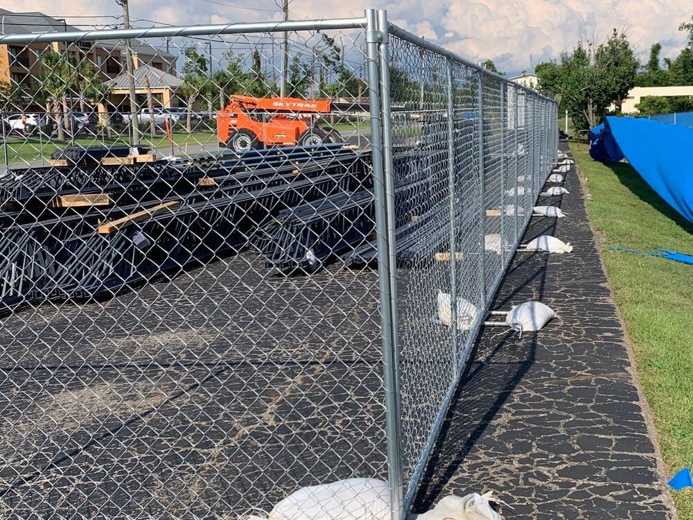 Tall galvanized temporary construction chain link fence at a job site in Panama City Florida
