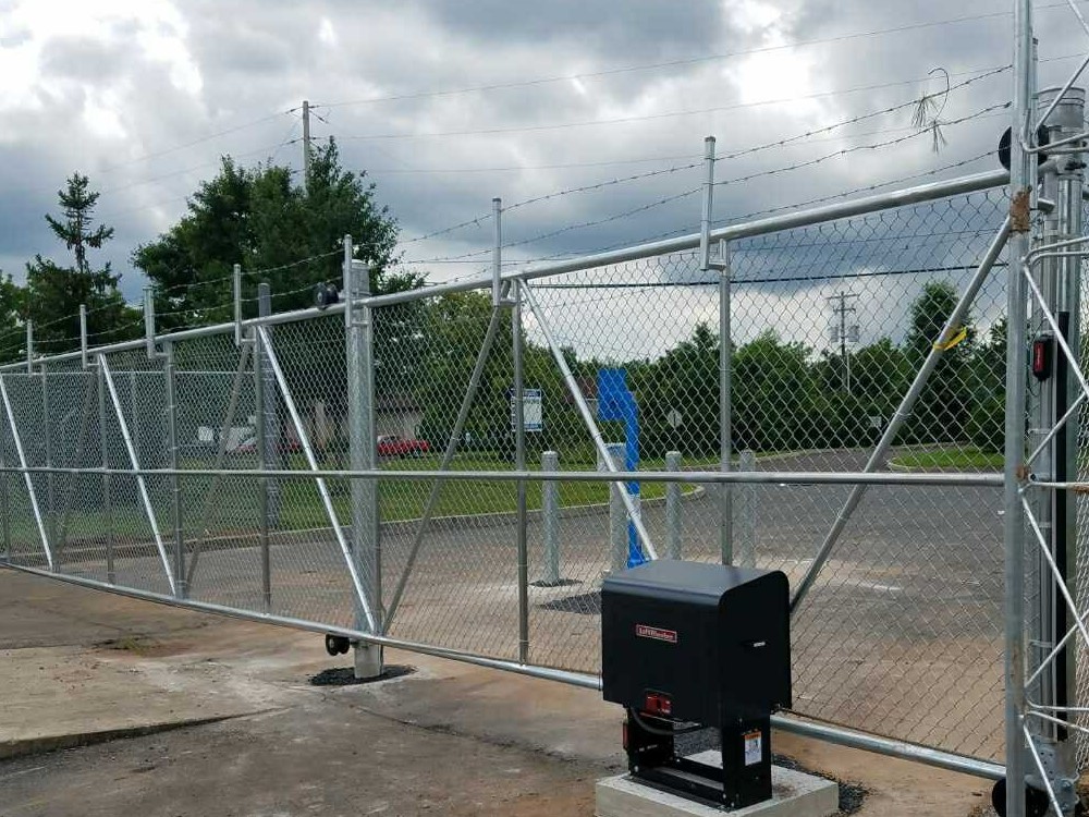 Galvanized chain link cantilever gate with an automatic gate operator on a concrete pad