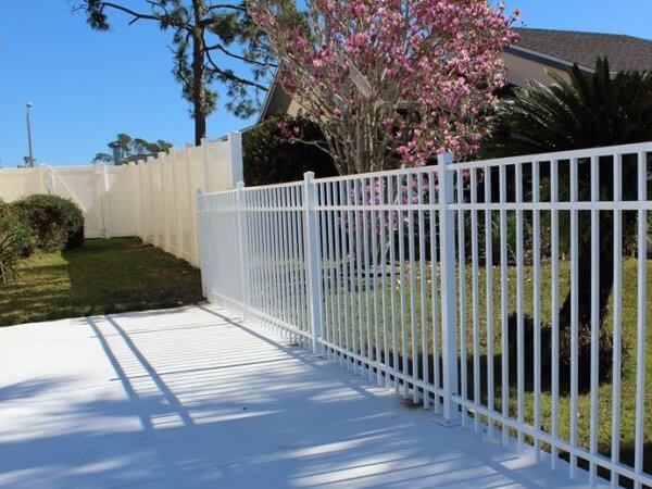 White aluminum decorative fence along a walkway