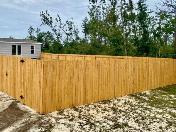 Wood privacy fence along a backyard