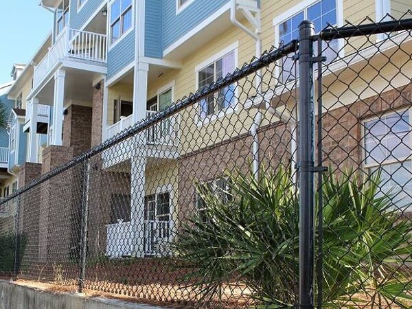 Chain link fence beside a multi-story building