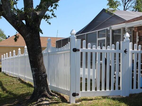 White vinyl scalloped picket fence with gate