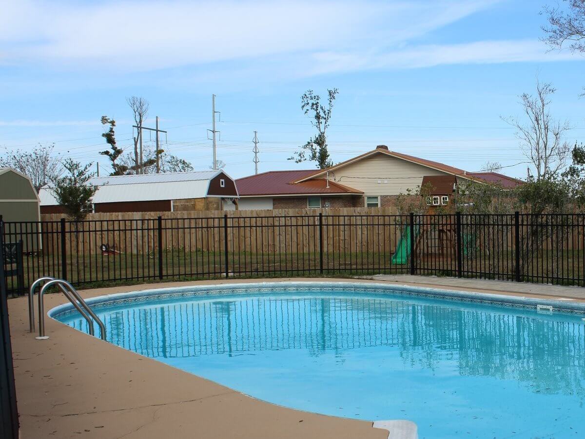 Wood privacy fence around a backyard pool