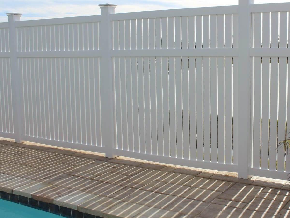 White vinyl privacy fence around a pool
