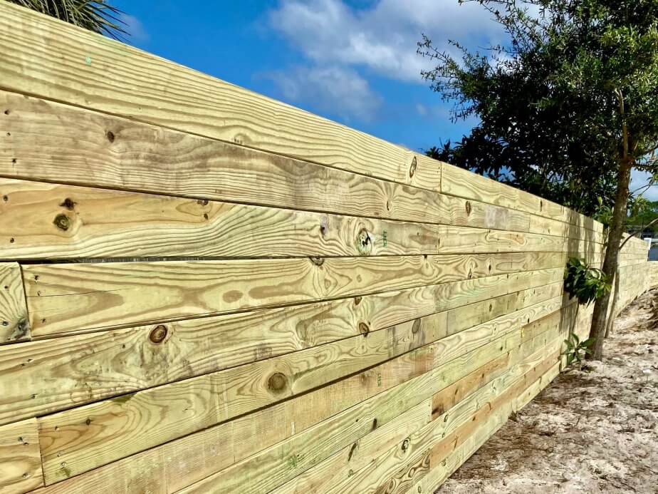 Contemporary horizontal wood privacy fence along a sandy path
