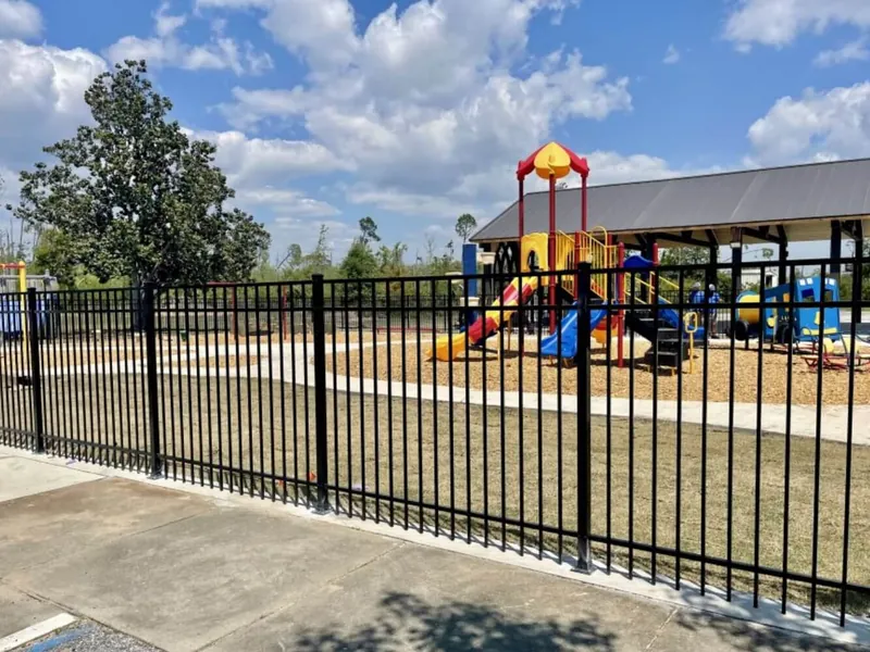 Black aluminum fence at a city park