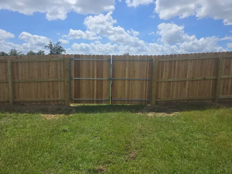 Wood privacy fence with double drive gate